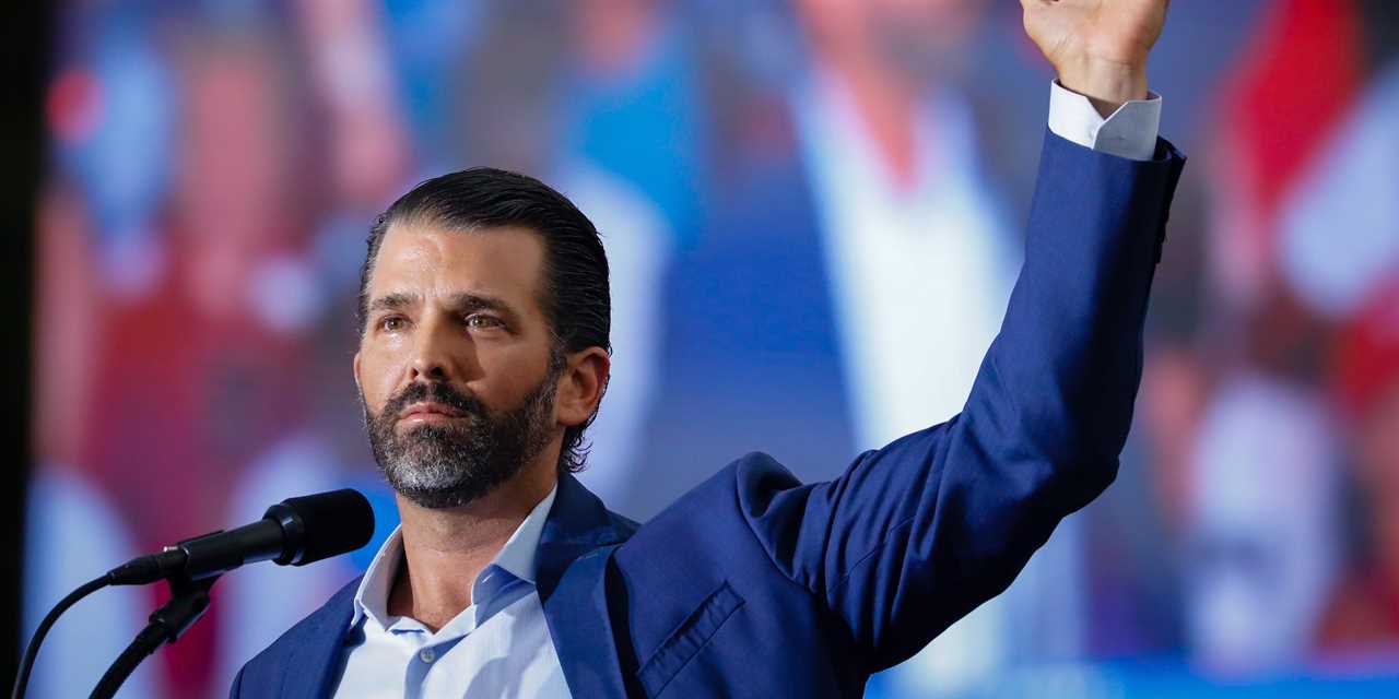 Donald Trump Jr. gestures toward the ceiling during a CPAC speech in Dallas, Texas.