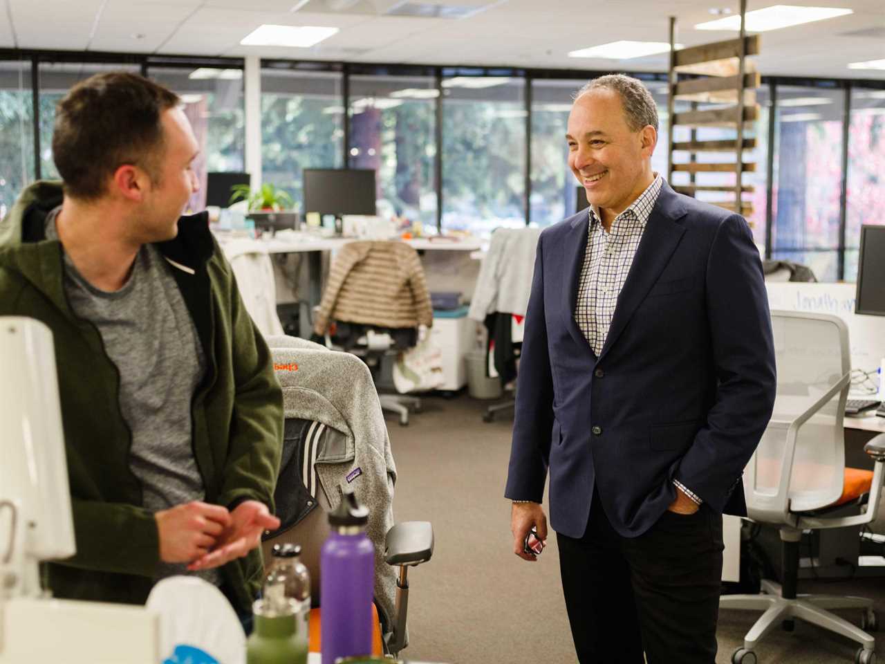 Dan Rosensweig, CEO of Chegg, talking to someone in an office