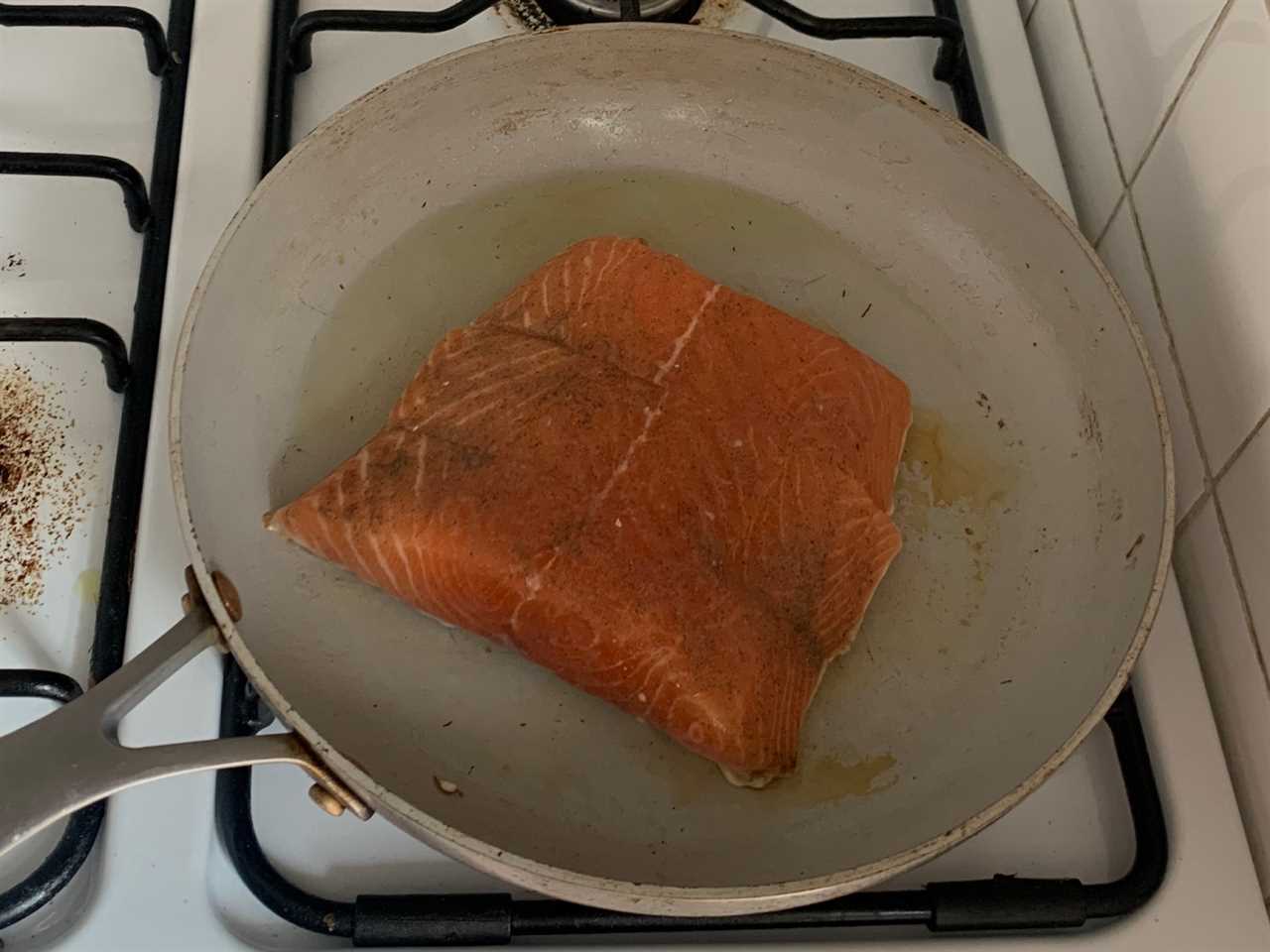 Seasoned salmon in pan