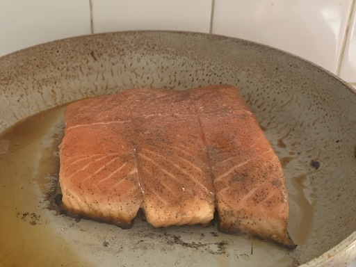 Cooked and seasoned salmon in pan