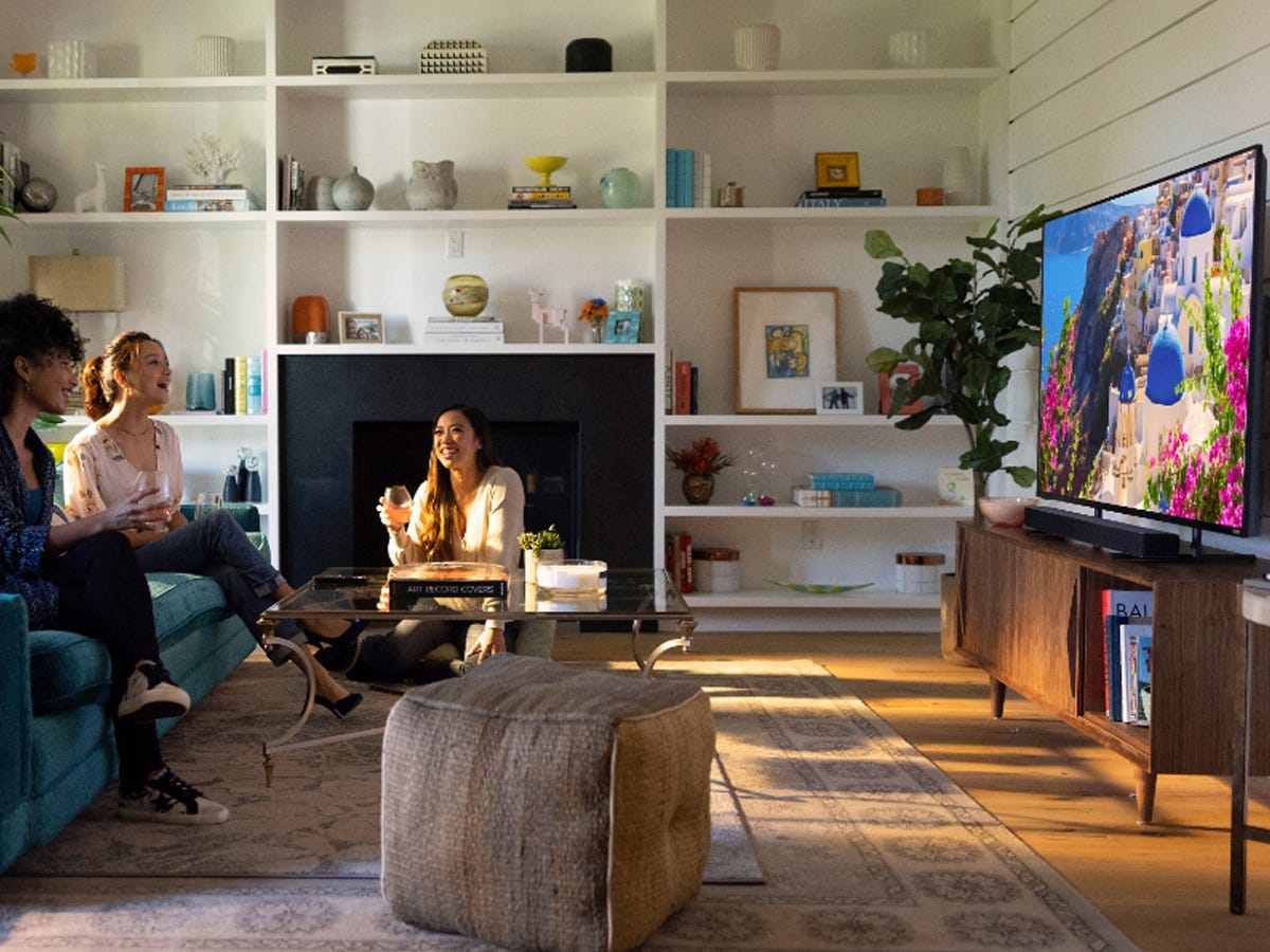 A group of people watching TV in a furnished living room using the V-Series V21d-J8 soundbar