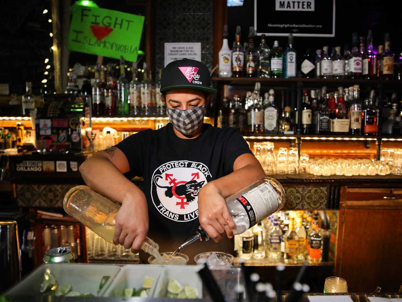 masked bartender makes drinks in San Francisco