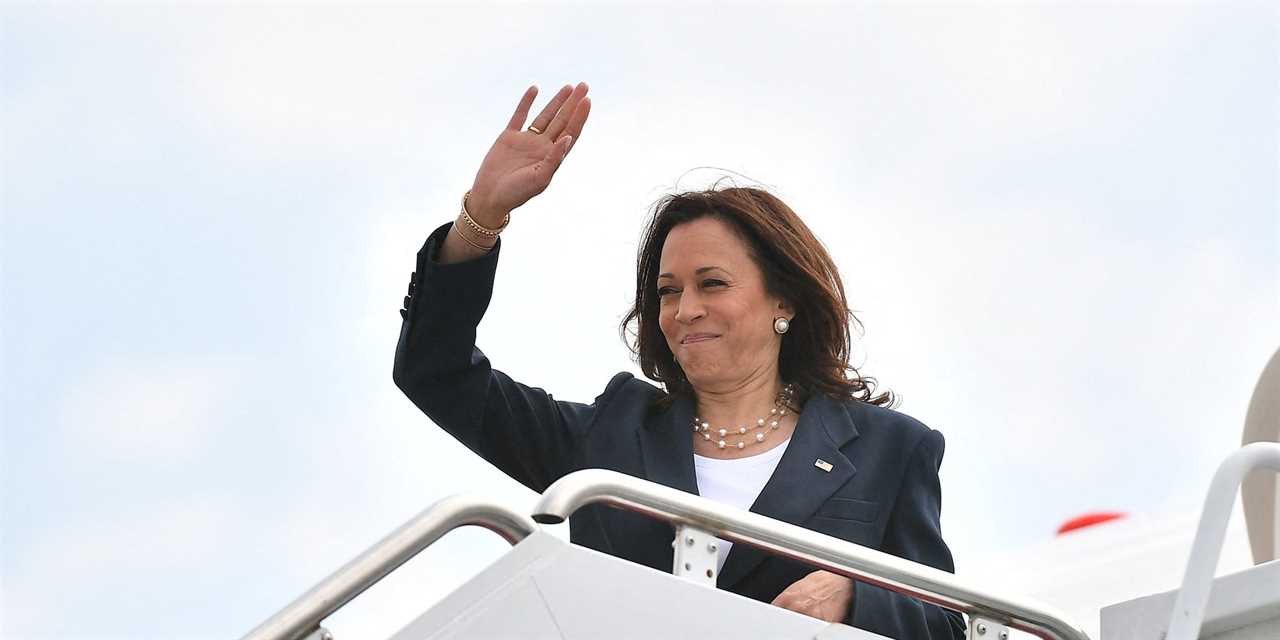 Kamala Harris waving from the steps of a plane.