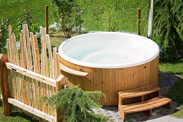 A wooden hot tub in the back yard