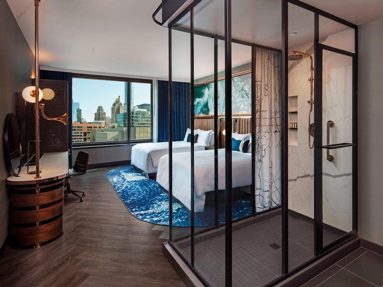 A guest room with an open shower at Hotel EMC2, Autograph Collection in Chicago.