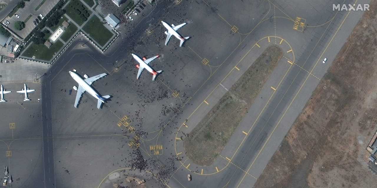 Satellite imagery shows crowds surround an Afghani airplane
