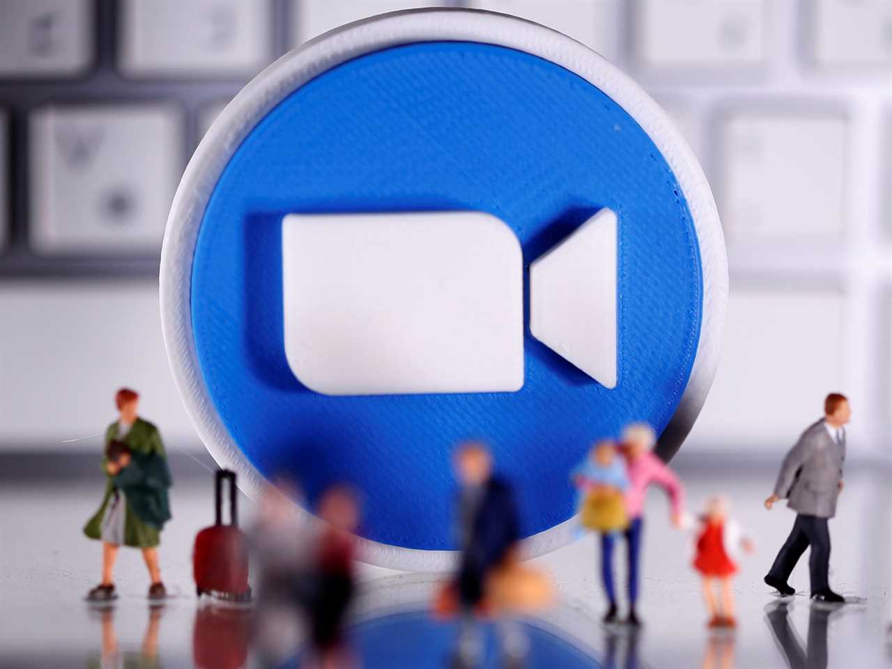 FILE PHOTO: A 3D printed Zoom logo is placed between small toy people figures and a keyboard in this illustration taken April 12, 2020. REUTERS/Dado Ruvic/Illustration