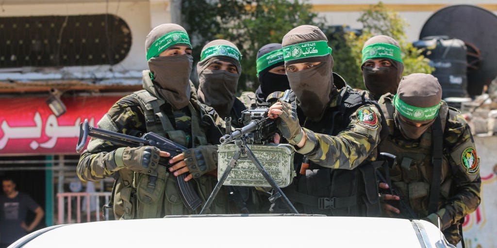 Members of the Al-Qassam Brigades of Hamas participate in a military parade in Osama Deeij's funeral.