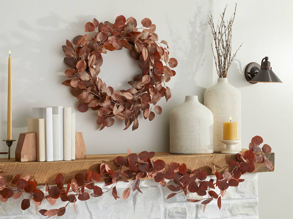 Image of an autumn wreath over a fireplace from Target best fall decor 2021