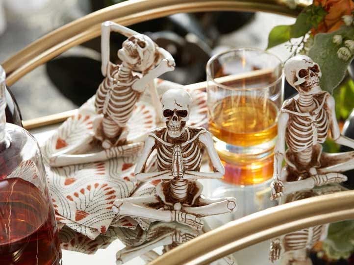 Image of yoga skeleton figures on a bar cart from World Market best halloween decorations 2021