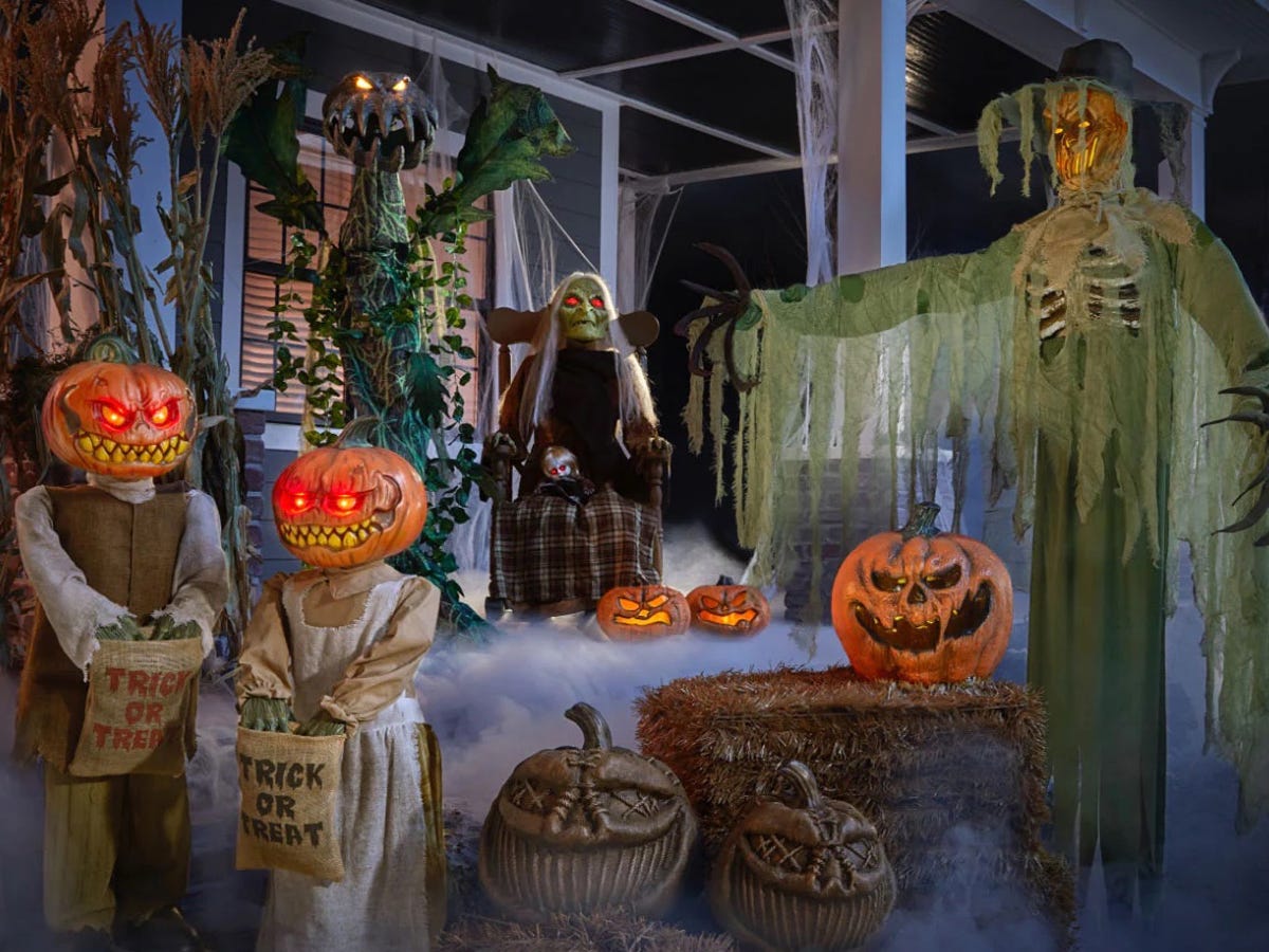 Image of a front porch covered in skeletons, zombies, and pumpkins from Home Depot, best Halloween decorations 2021