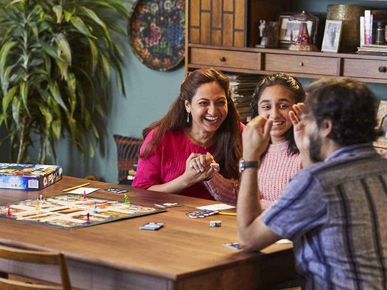 An image of a family playing the board game, Clue