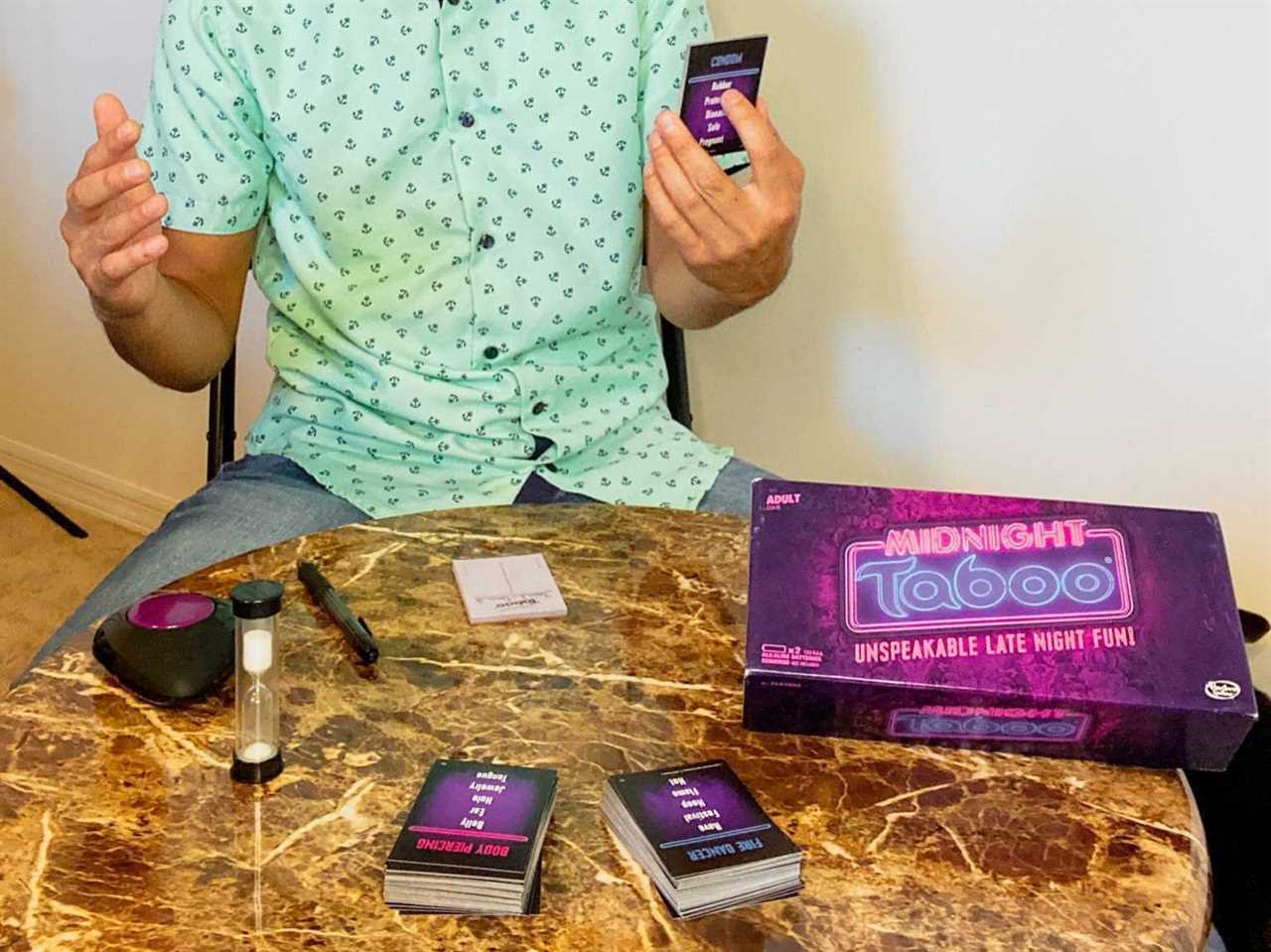 A man playing a board game called Midnight Taboo.