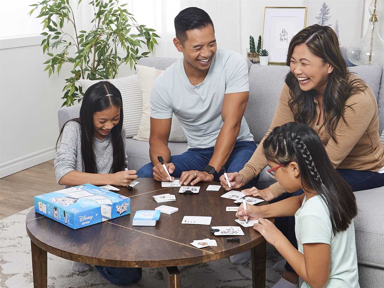 An image of a family playing Disney Sketchy Tales