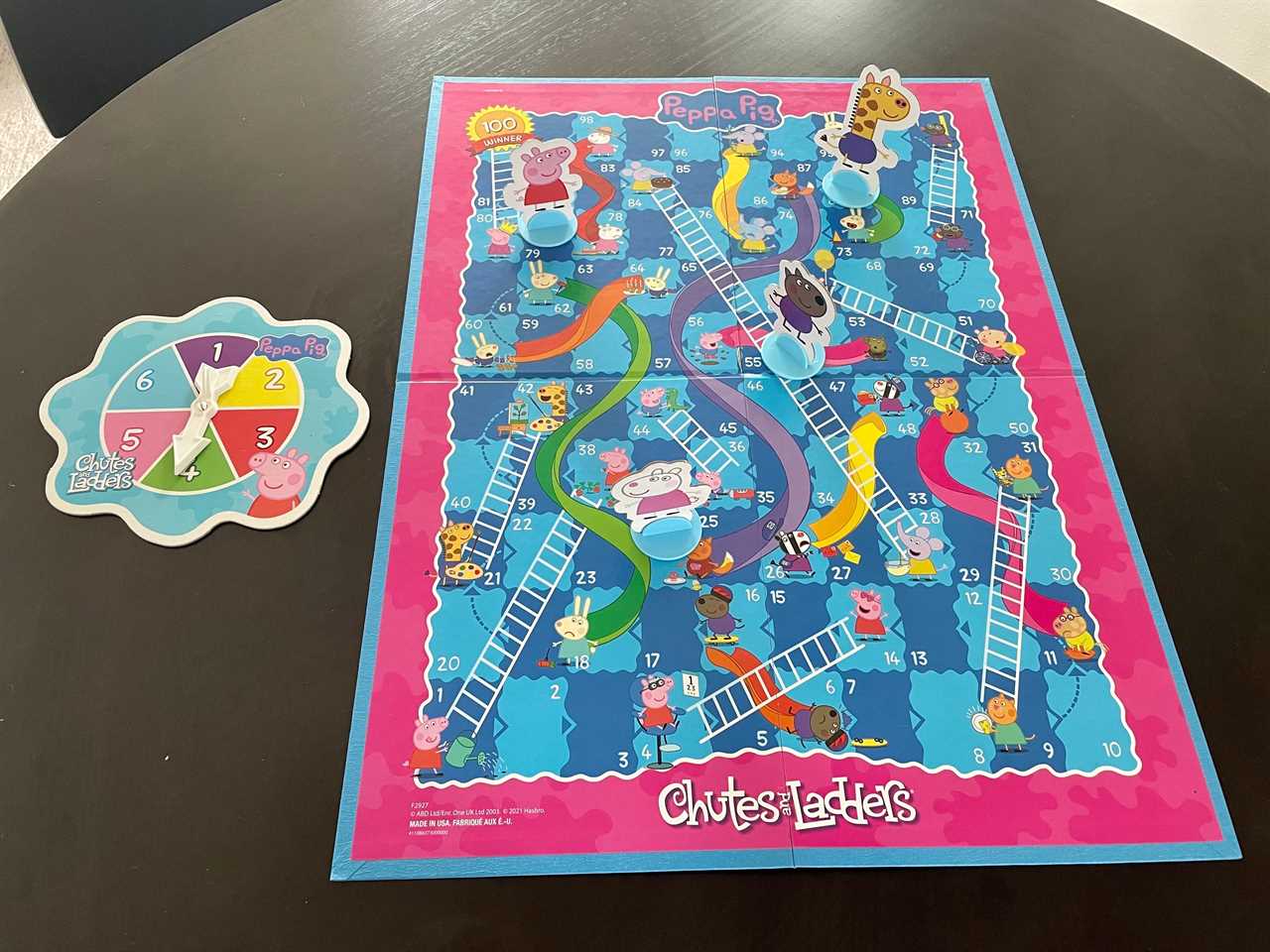 Image of the Peppa Pig themed chutes and ladders board game with the spinning wheel next to it, best board games 2021