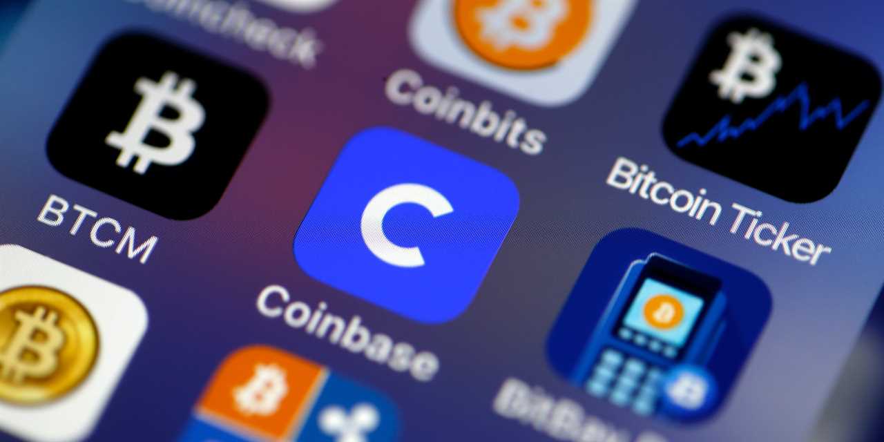 Coinbase cryptocurrency exchange logo is seen on the screen of an iPhone on February 26, 2021 in Paris, France.