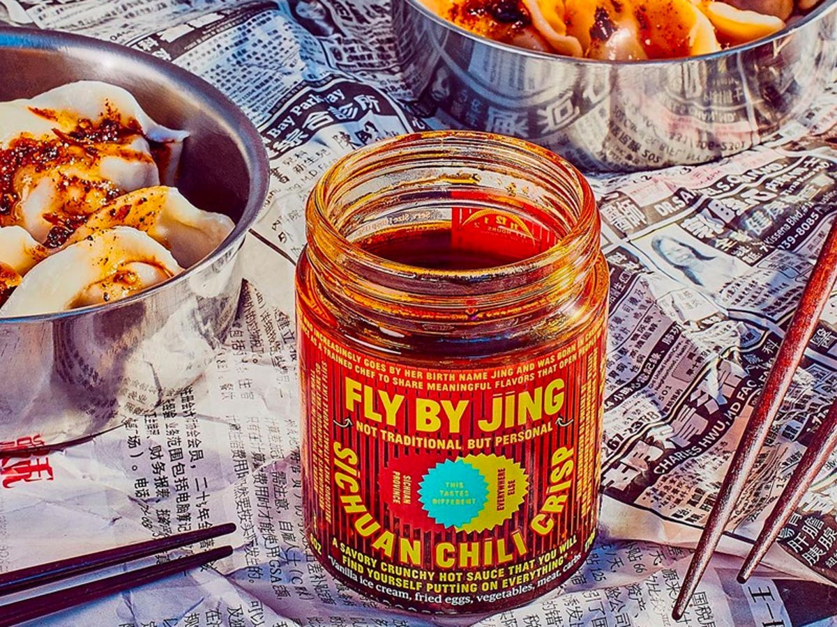 Fly by Jing Sichuan Chili Crisp on a table next to dumplings - Best Asian American food and drink brands in 2021
