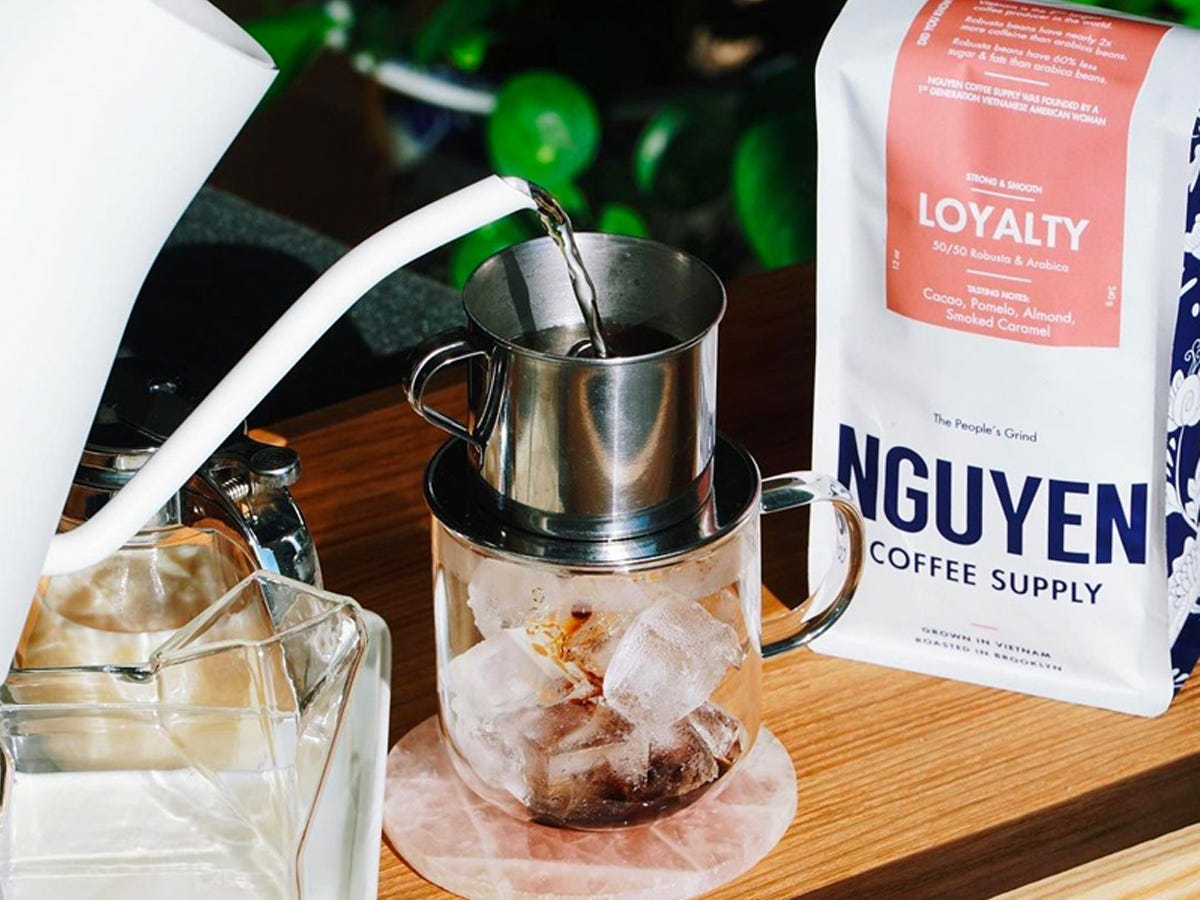 Water being poured into a phin coffee pourover filter to make a cup of Nguyen Coffee Supply coffee - Best Asian American food and drink brands