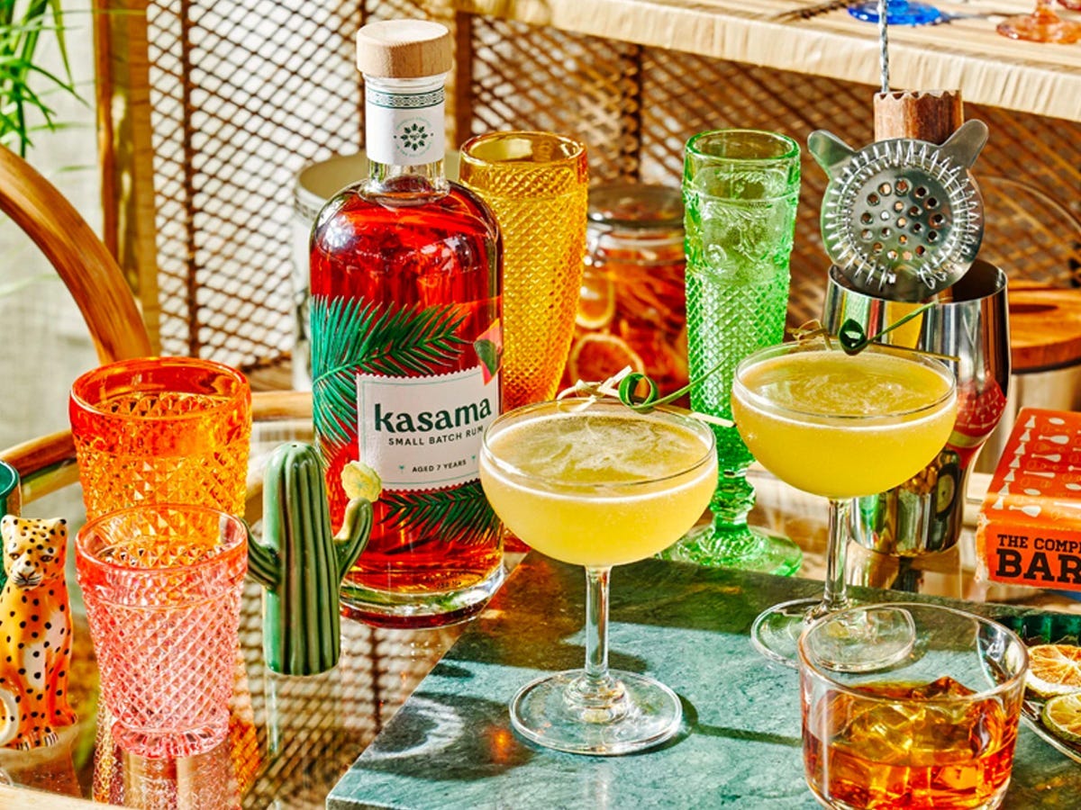 Bottle of Kasama Rum on a bar cart with barware and cocktails - Best Asian American food and drink brands in 2021