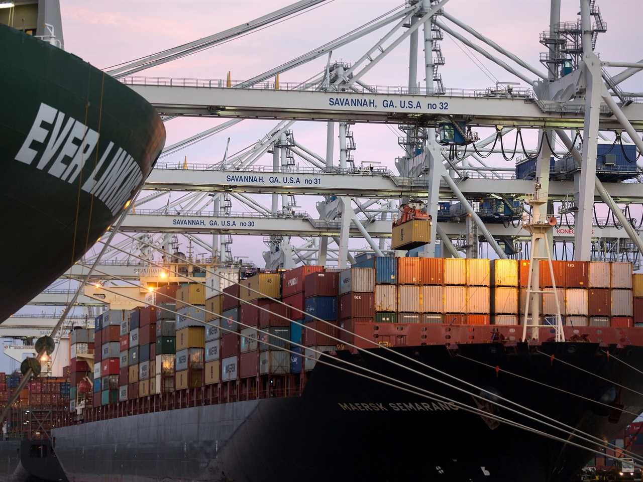 In this June, 19, 2018 photo, several ship to shore cranes stack shipping containers on-board the container ship Maersk Semarang at the Port of Savannah in Savannah, Ga.