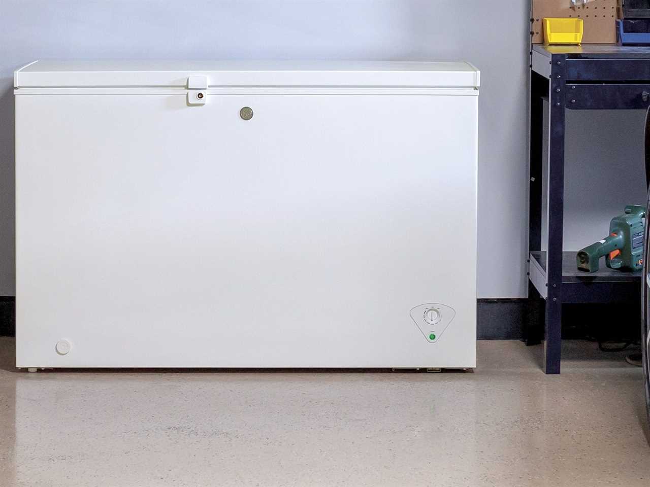Image of the GE FCM7SKWW freezer in a garage near a shelving unit with tools for best freezer of 2021