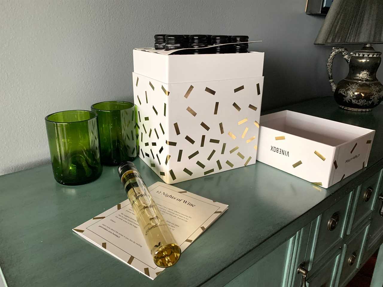 Image of tube of wine and wine glasses next to Vinebox wine advent calendar for best advent calendars 2021