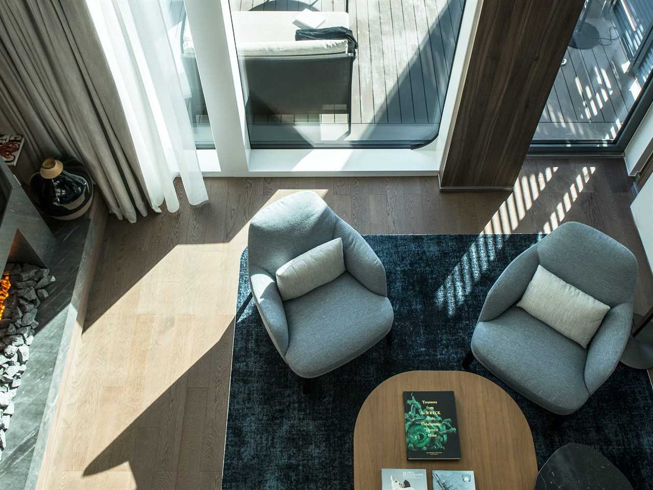 overhead view of two chairs by a large window and balcony