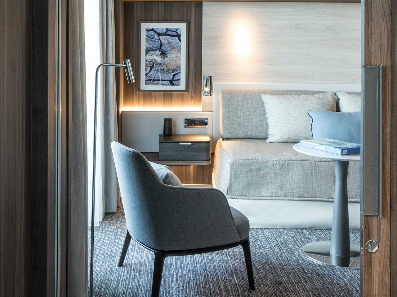 a couch and chairs in a modern, well lit room