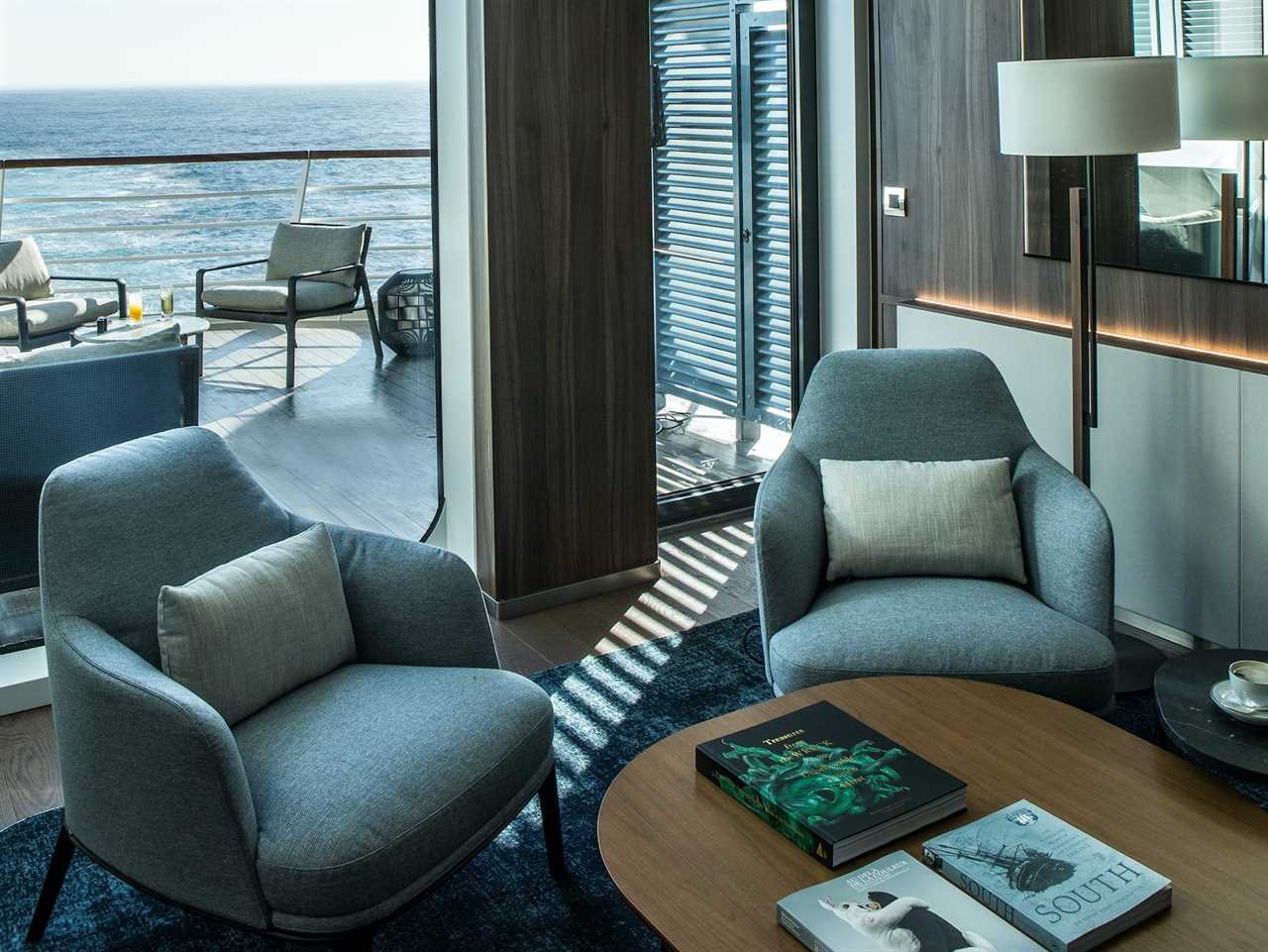 two chairs in front of a window looking at an outdoor balcony