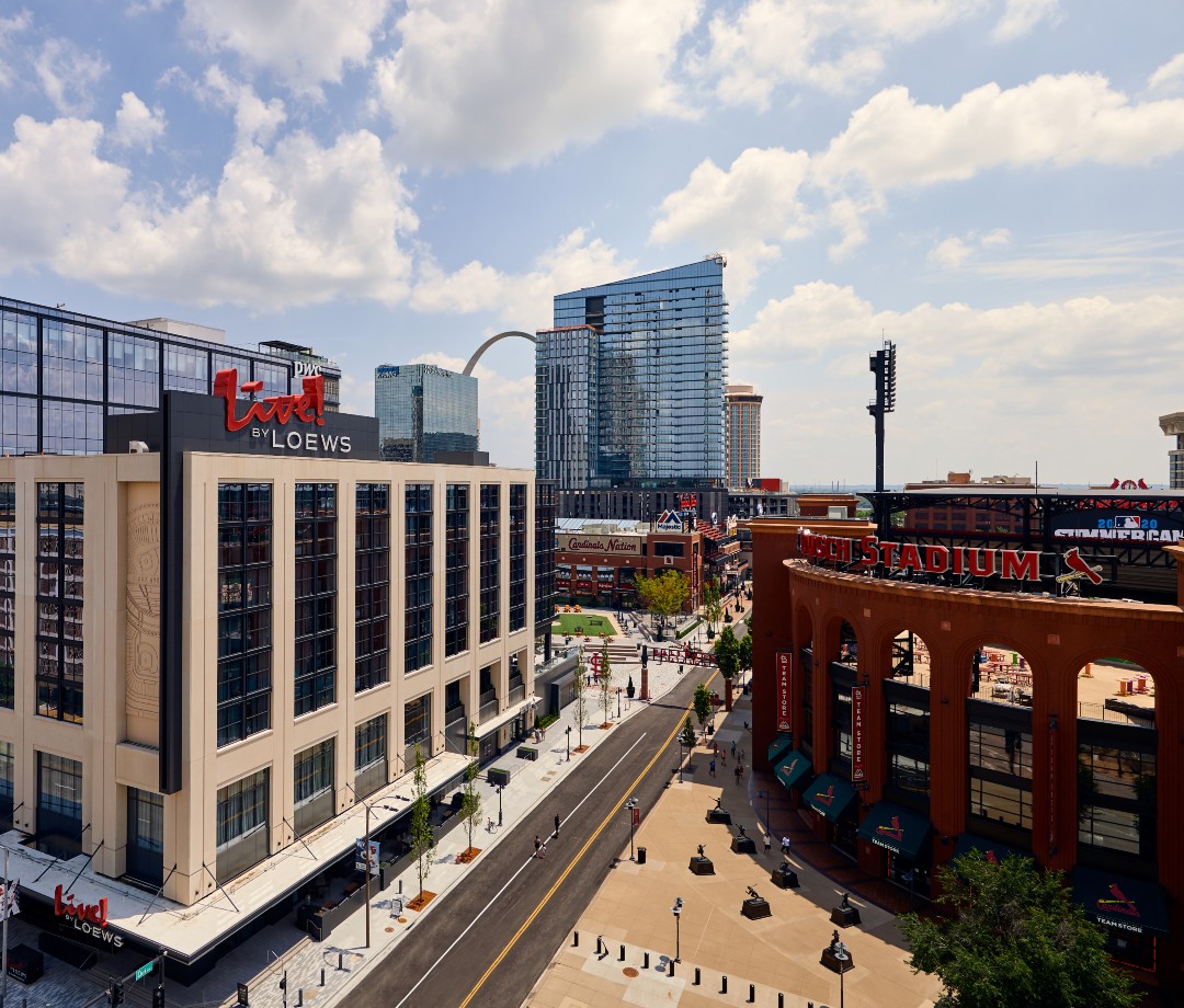 Exterior of hotel with read sign that reads Live! by Loews across the street from baseball stadium