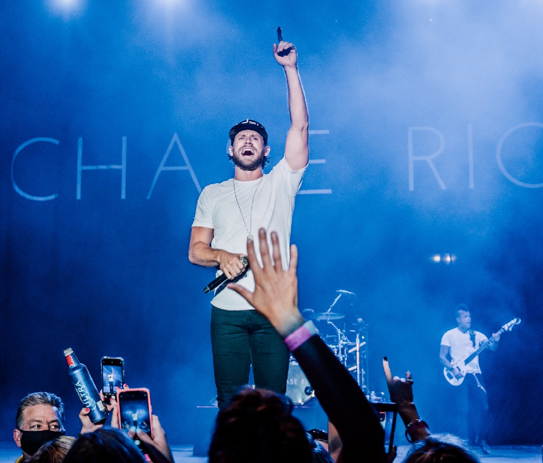 Chase Race on stage performing at a concert.