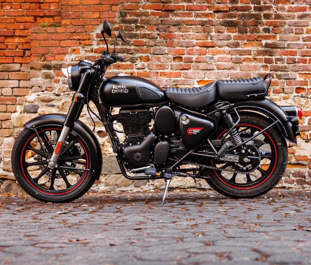Royal Enfield Classic 350 parked beside a red brick wall