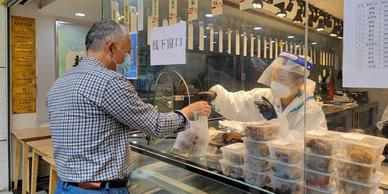 A man buys food in Shanghai, China. Shanghai lifted some COVID-19 lockdown restrictions on June 1, 2022.