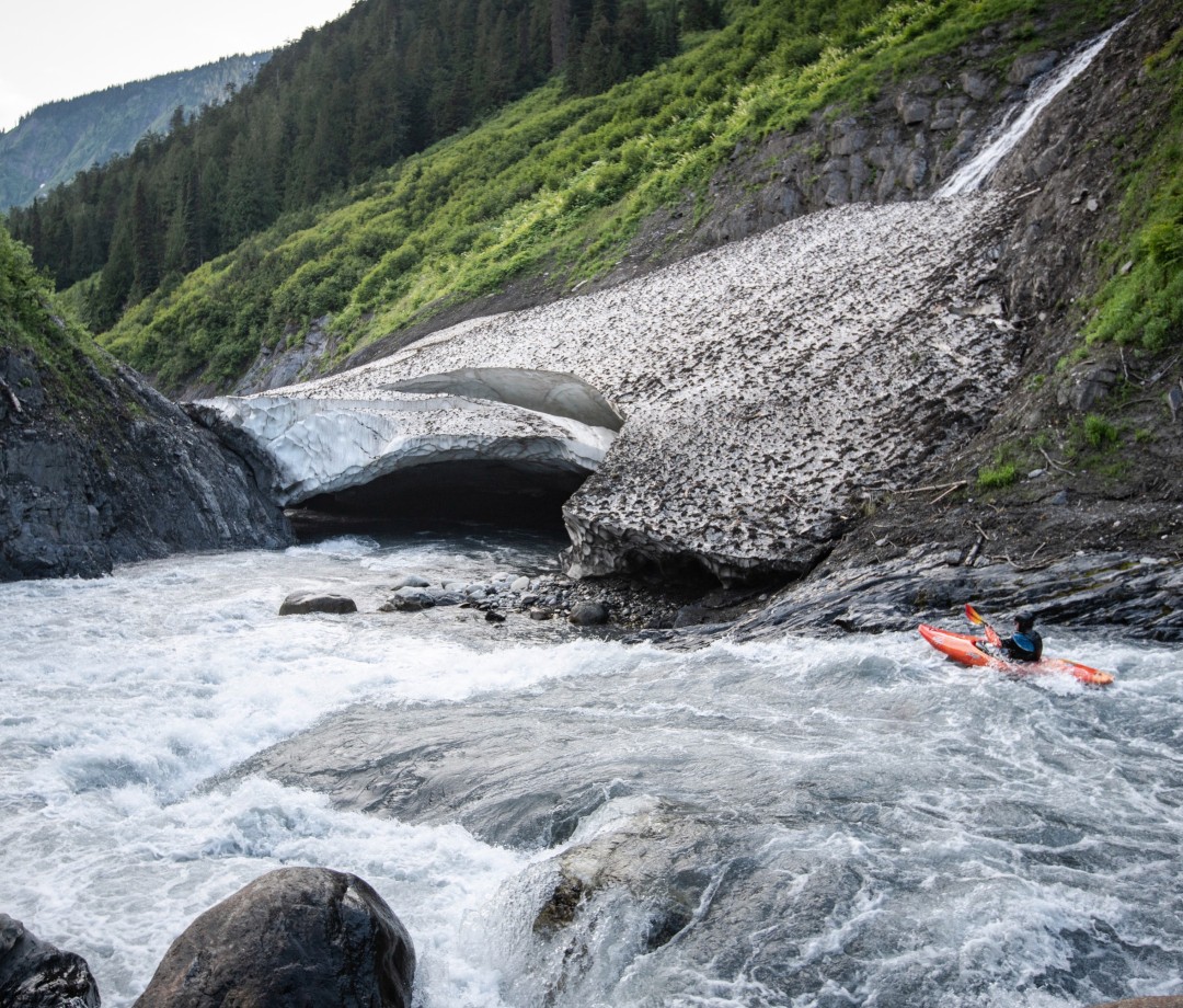Kayaker in water woods and ice