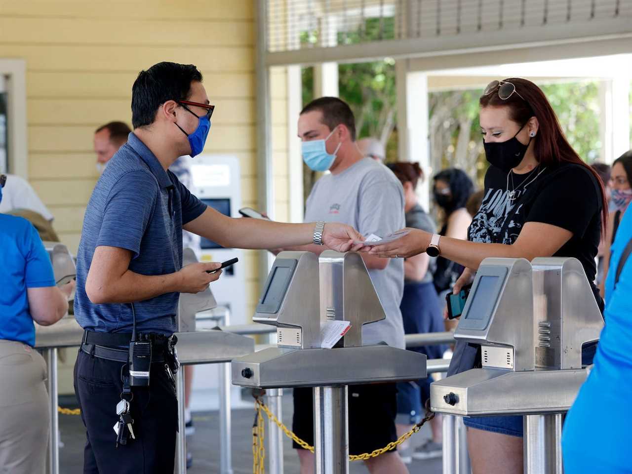 People have their tickets scanned as they enter Six Flags Discovery Kingdom
