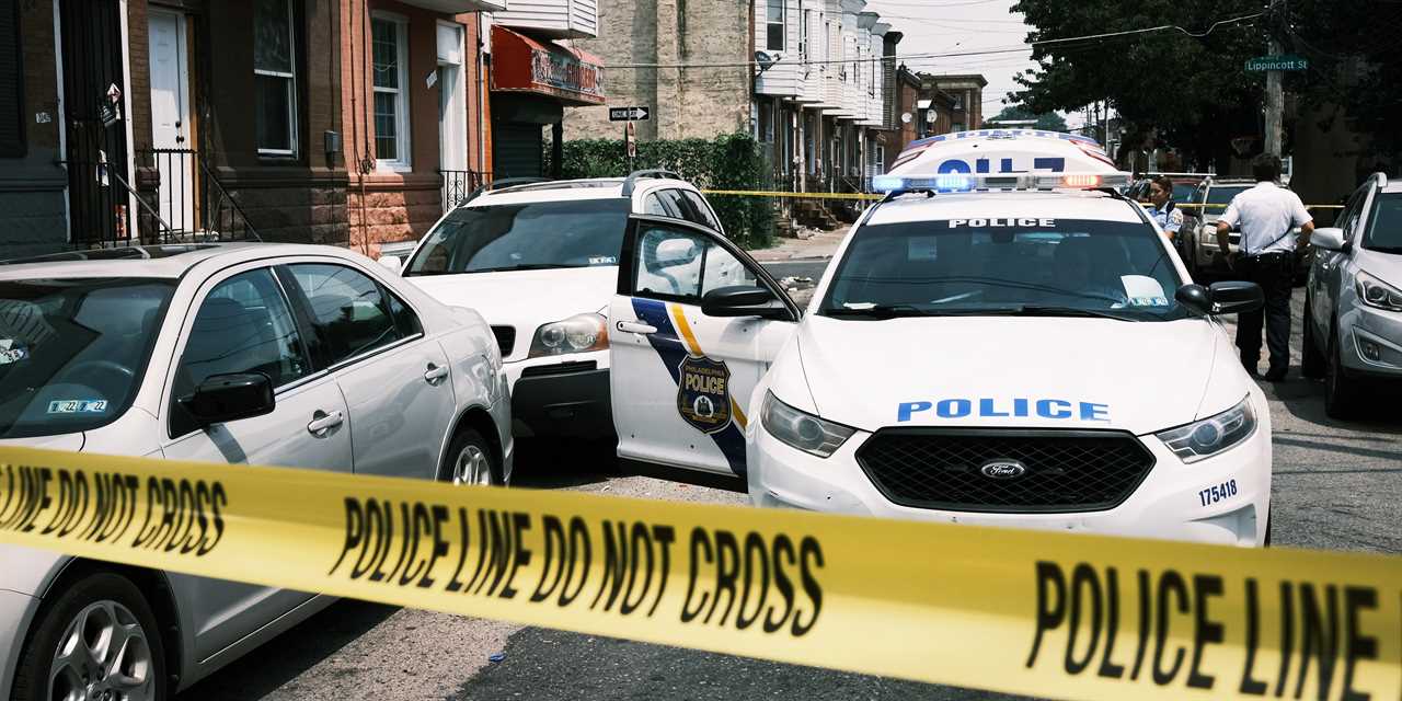 Police tape in front of cop car