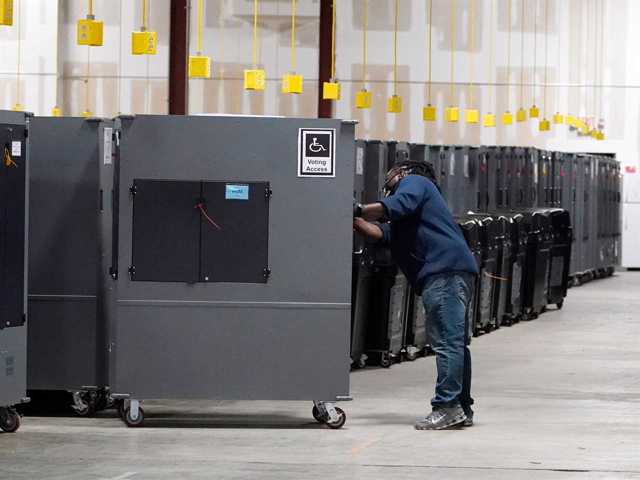 - A worker returns voting machines to storage at the Fulton County Election preparation Center Wednesday, Nov. 4, 2020 in Atlanta, Georgia.