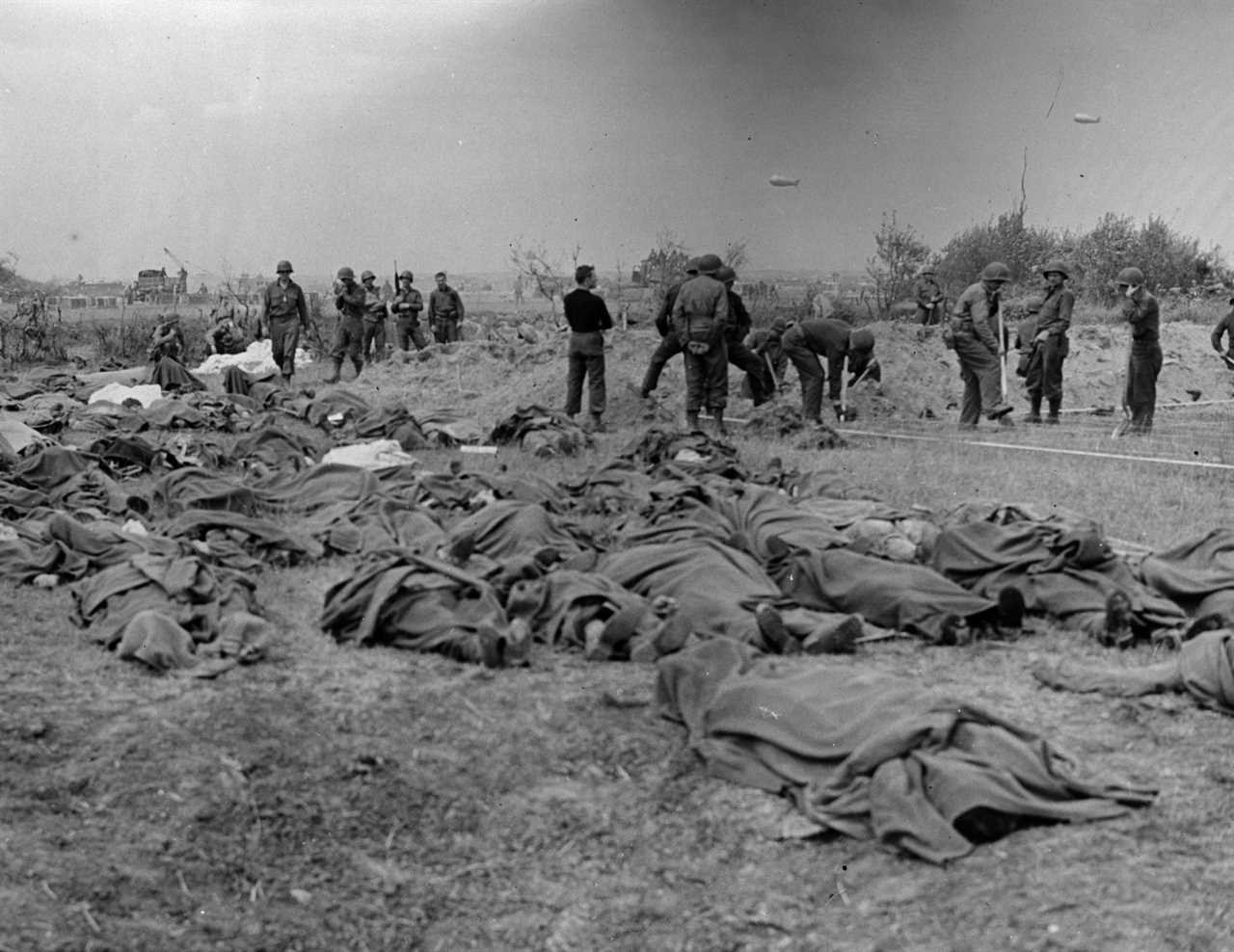 The bodies of American soldiers lie on the ground in Normandy, France, awaiting burial, following the D-Day Allied invasion.