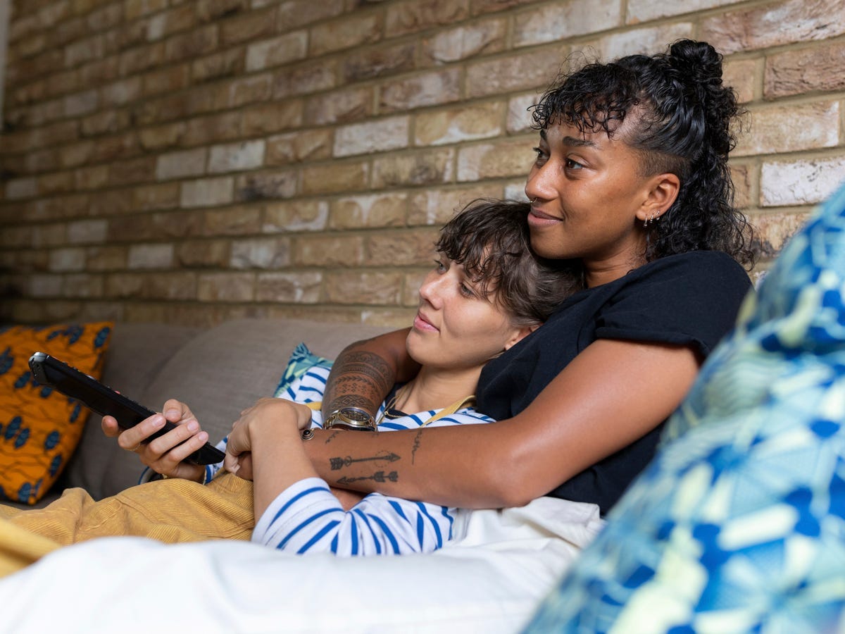 Watching TV on the couch together.