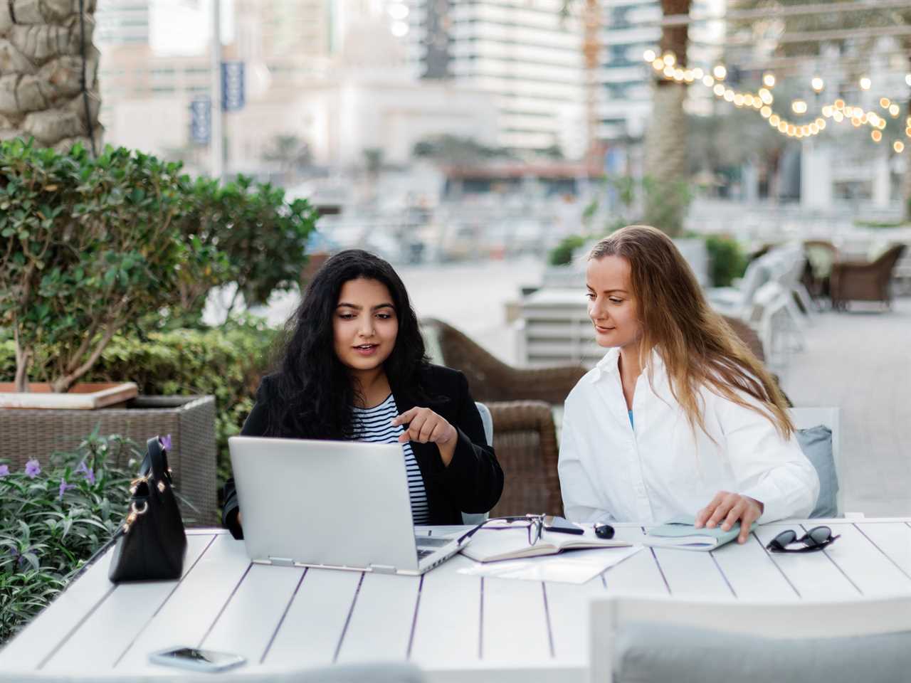 Two Women Discuss A Common Project During Their Lunch Break