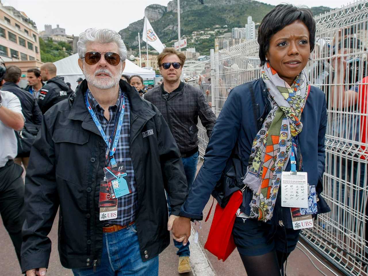 George Lucas and Mellody Hobson hold hands while walking at Monaco racetrack