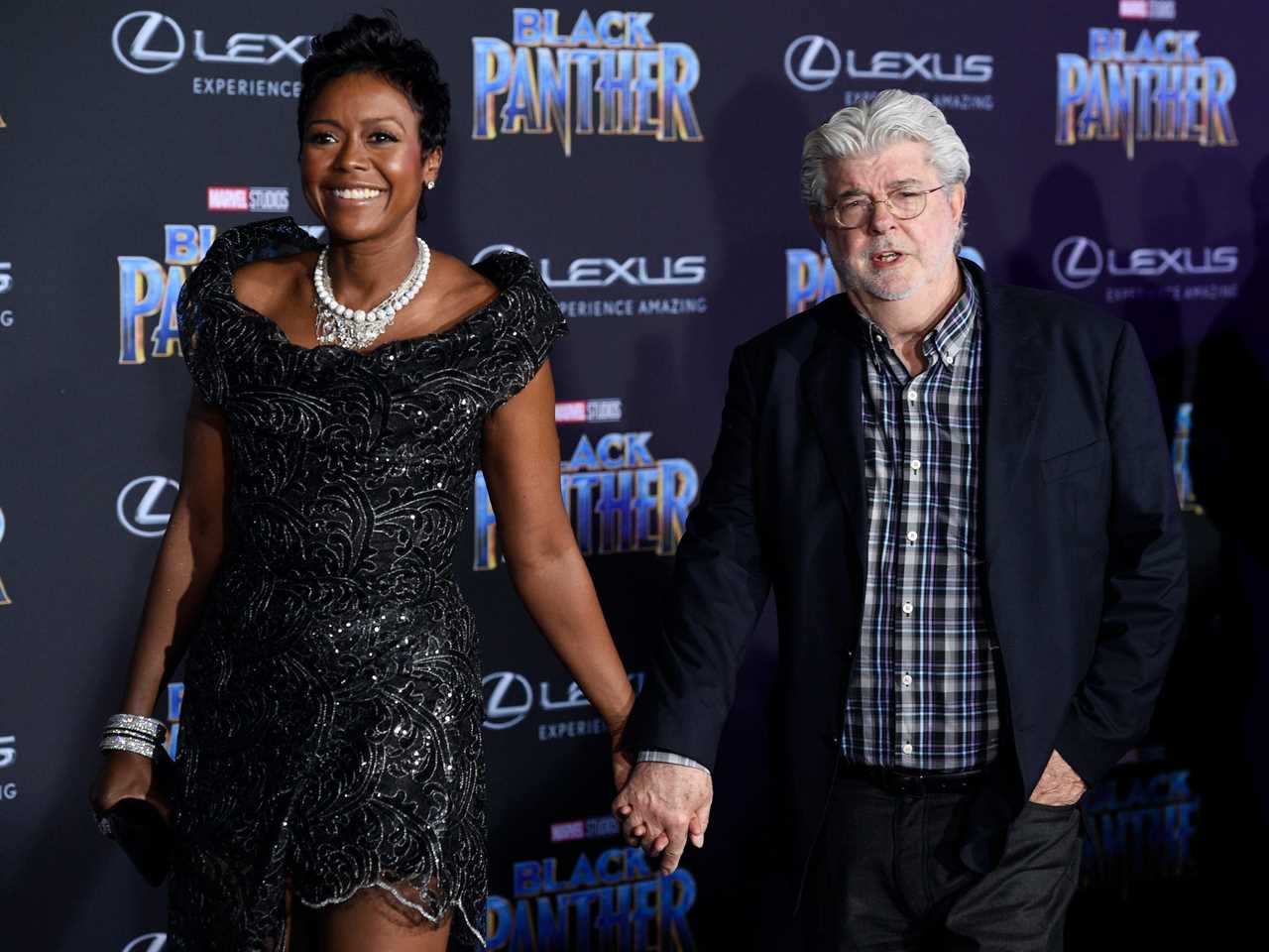 Mellody Hobson holds hands with George Lucas at "Black Panther" premiere