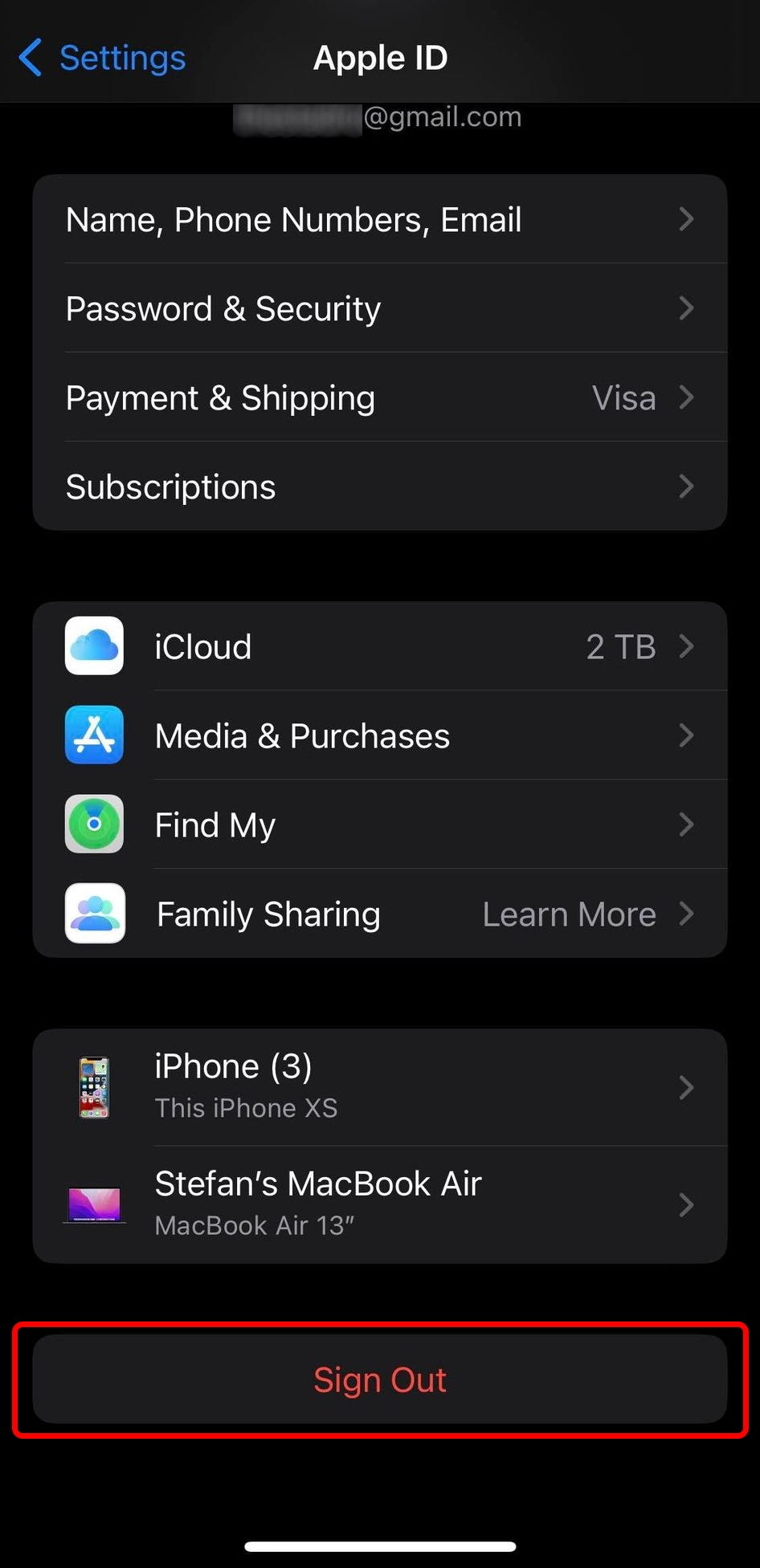 The Apple ID settings on iPhone, with the “Sign Out” option highlighted at the bottom.