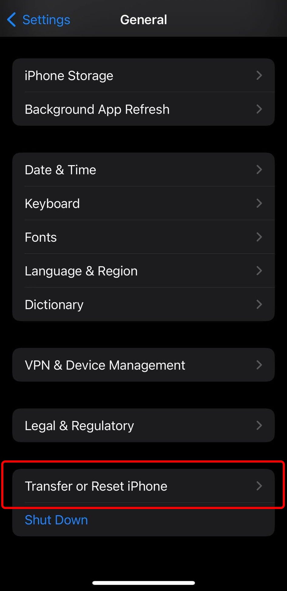 The General settings on iPhone, with the “Transfer or Reset iPhone” option highlighted.