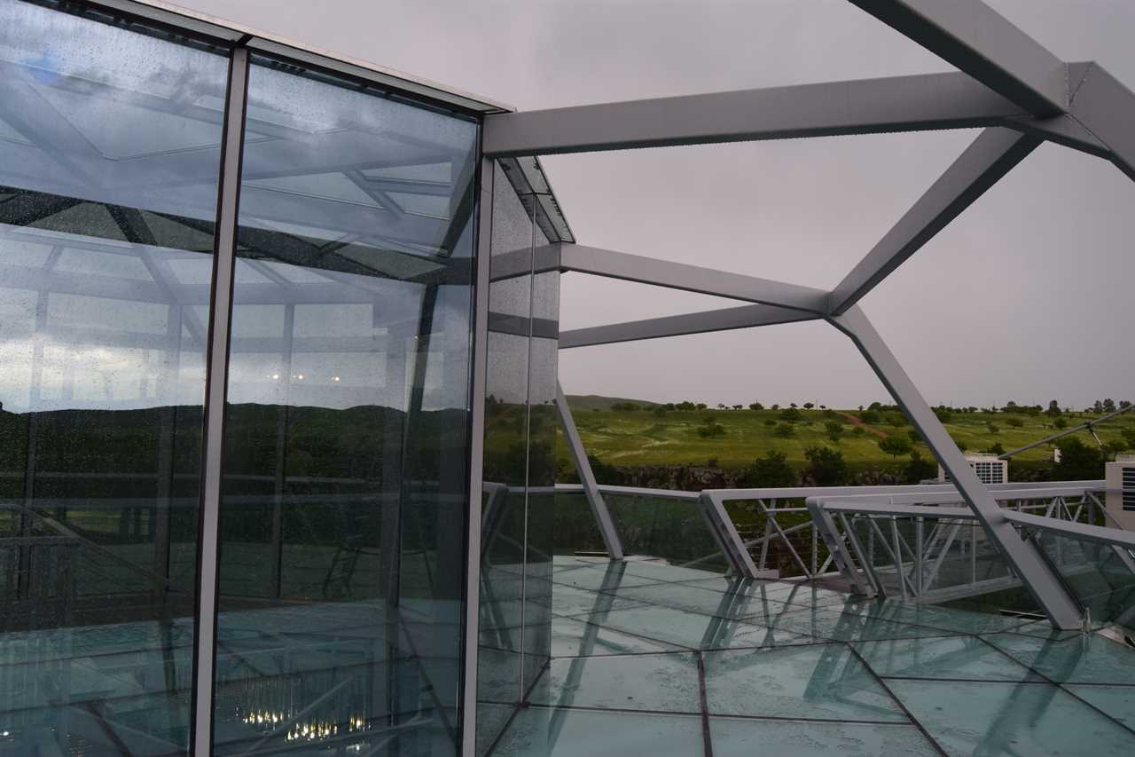 a glass bridge and diamond-shaped bar in the middle, suspended over the Dashbashi Canyon in Georgia