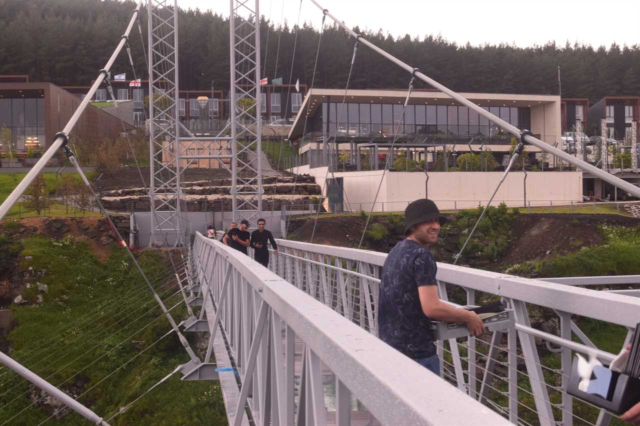 a glass bridge and diamond-shaped bar in the middle, suspended over the Dashbashi Canyon in Georgia