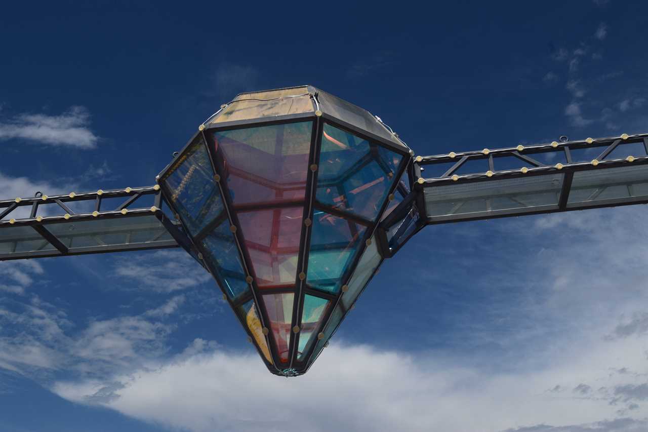 a glass bridge and diamond-shaped bar in the middle, suspended over the Dashbashi Canyon in Georgia