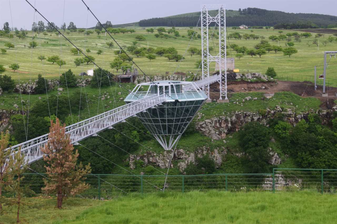 a glass bridge and diamond-shaped bar in the middle, suspended over the Dashbashi Canyon in Georgia