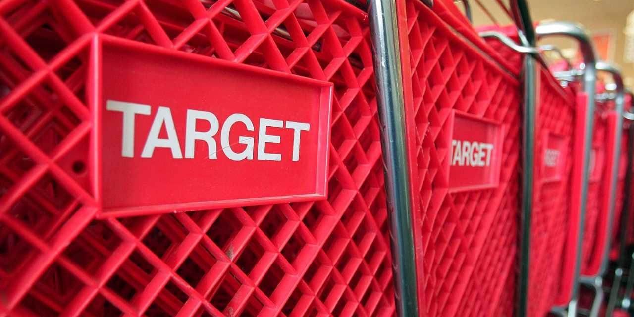Red shopping carts sit inside a Target store.