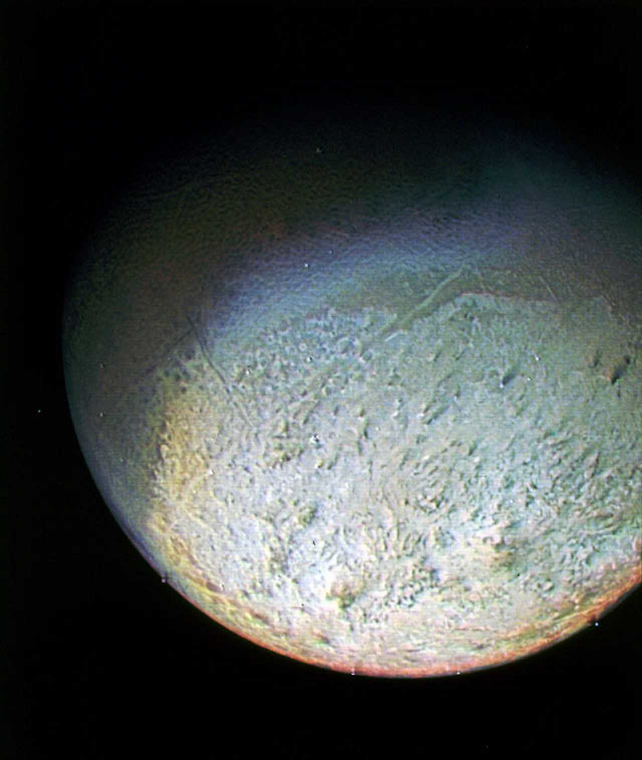 A picture shows Triton's southern hemisphere, which looks uneven.